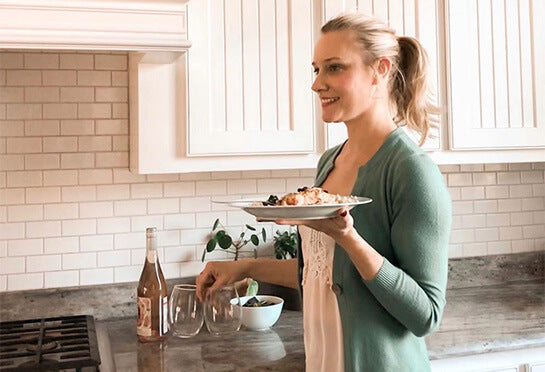 Woman with a hot meal in a clean kitchen